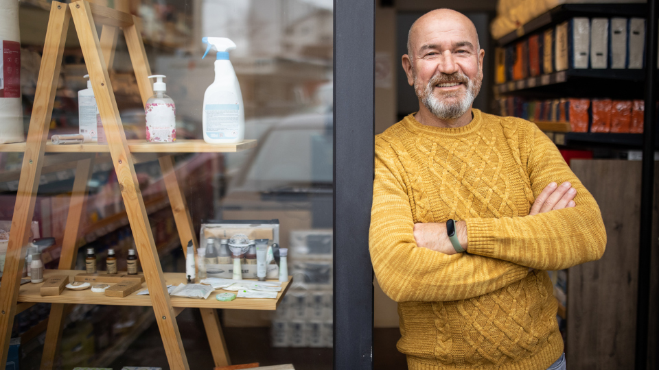 Small business owner in front of his shop