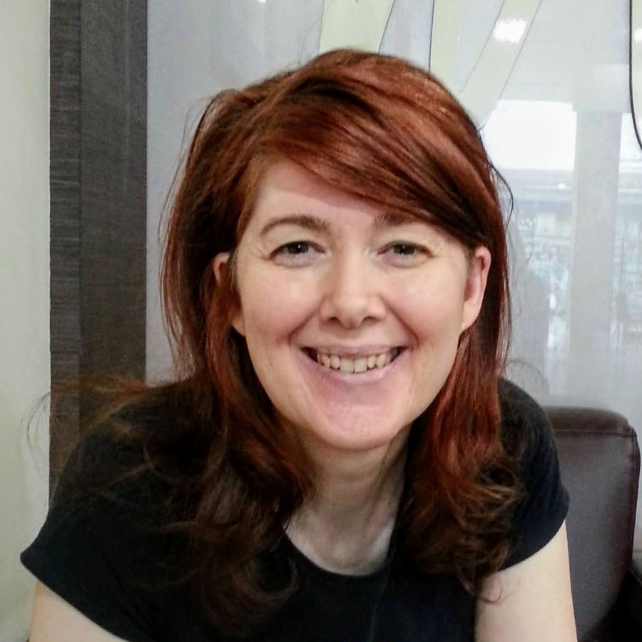 Pamela Wilson - a dark haired lady smiling 