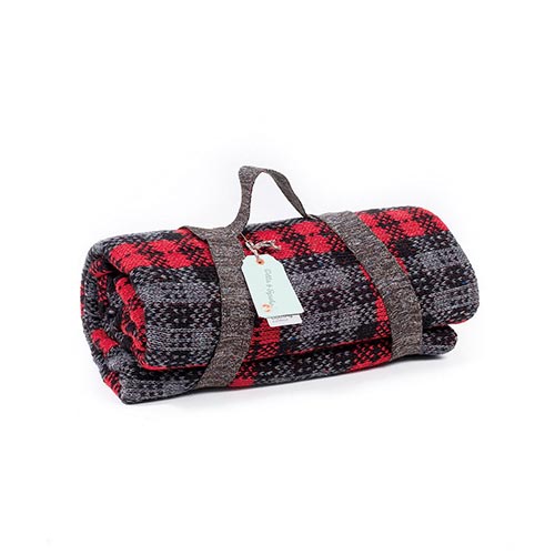 A red and black Mcfadyen lambswool picnic rug. It is rolled up and has a carry handle.
