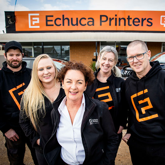 Five people standing outside of Echuca Printers smiling at the camera.