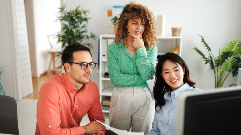 3 people looking at the computer screen and thinking 